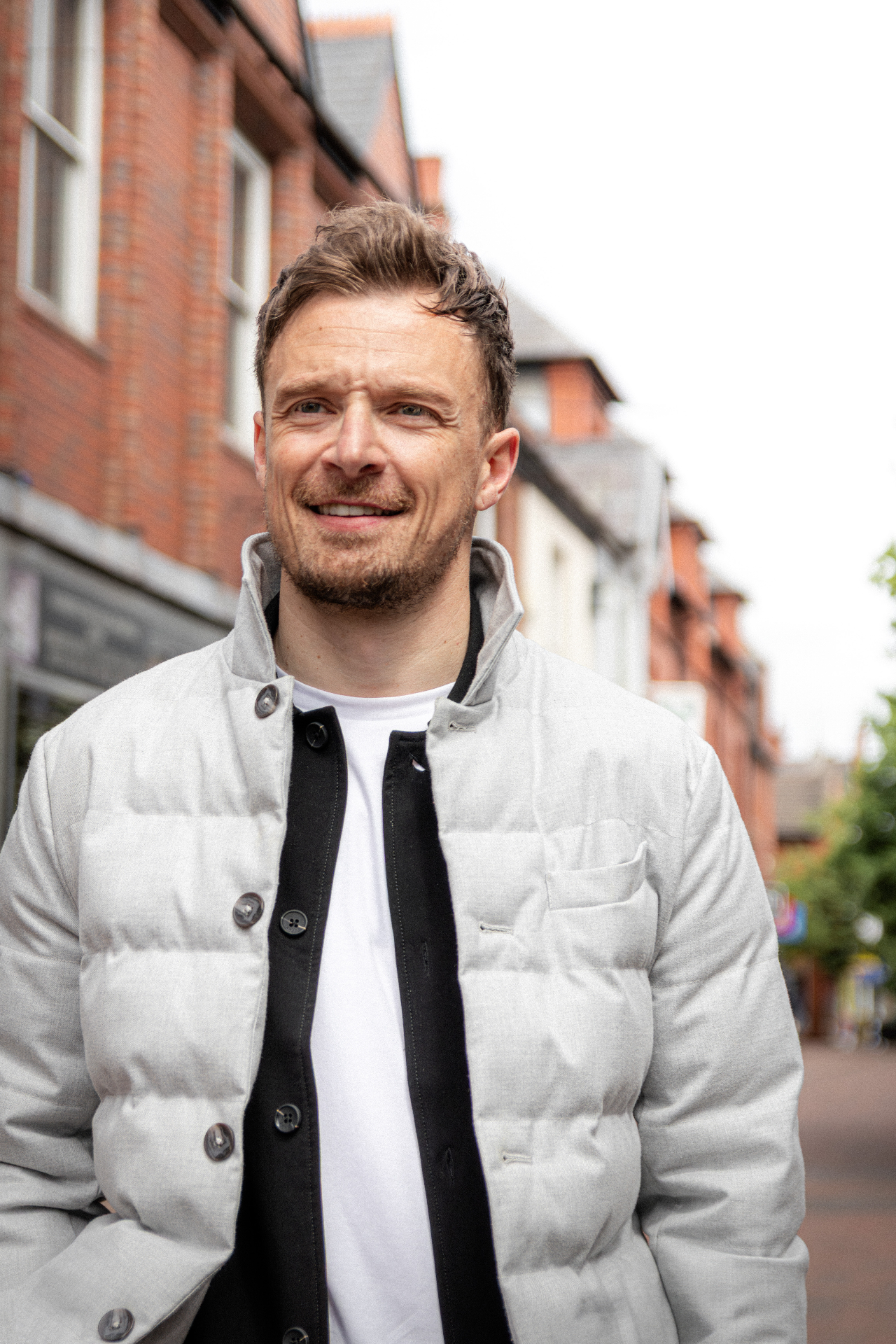 Josh, founder of Calibra Accountancy, smiling on a Cheshire high street